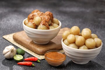 Cilok with spicy peanut sauce, a snack with a chewy and savory texture, with a spicy taste that...
