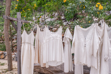 Different clothes drying on laundry line against garden background,clothes hanging laundry on...