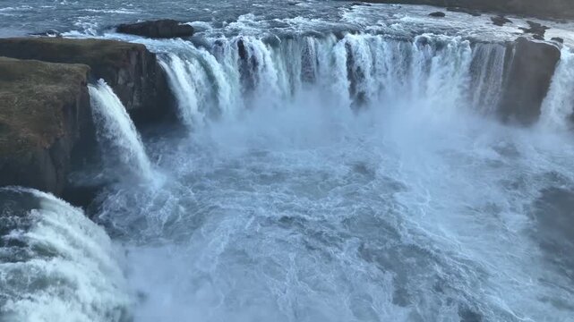 Aerial view of the powerful, cascading waters of Go&eth;afoss waterfall contrasting against the dark rocks, pingeyjarsveit, Iceland.