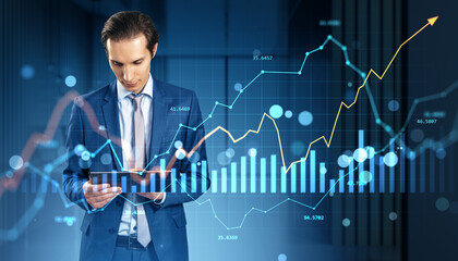 Businessman analyzing financial data on digital tablet with dynamic stock market chart and holographic currency graphs in modern office background.