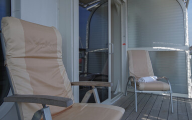 Lounge deck chairs onboard terrace balcony veranda patio of suite stateroom onboard luxury...