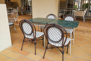 Classic white steel chair and table in the garden,empty white vintage chairs in the garden,decoration english garden concept.