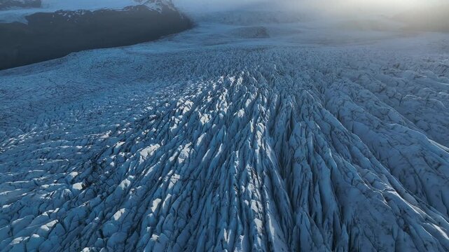 Aerial view of glacial ice formations reveal an icy landscape of deep crevasses and mountain peaks, contrasting textures, Hornafjor&eth;ur, Sveitarf&eacute;lagi&eth; Hornafjor&eth;ur, Iceland.