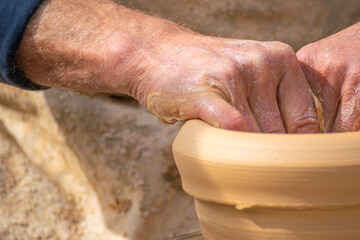 A moment of focus and creativity as a potter works with clay in his studio creative expression concept