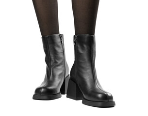 Women's shoes on a white background. Close up of a women's black leather chelsea boots on white...