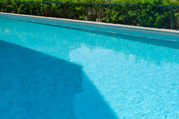 Empty swimming pool with table and chairs in summer,sofa resort neary sea and beach,restaurant and lunch,rest vacation concept.