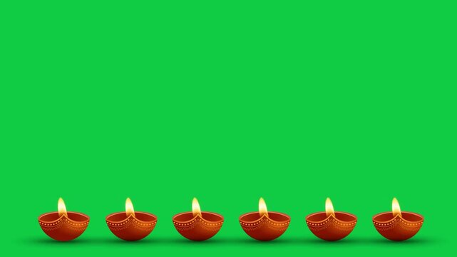 Oil lamps burning in three different ways on a green background. Diwali celebration, festival of lights, Karthika Deepa Festival.
