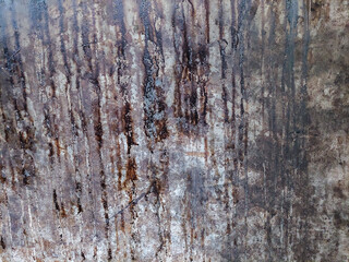 Old damaged grunge wall with rust stains on concrete surface for vintage industrial design. Wall texture.