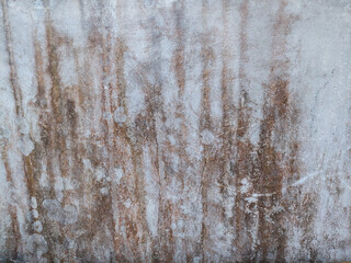 Old damaged grunge wall with rust stains on concrete surface for vintage industrial design. Wall...