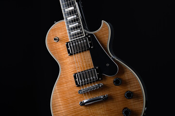 Electric guitar with natural pattern isolated on black background.