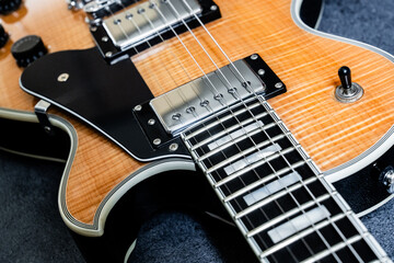 Electric guitar with natural pattern isolated on black background.