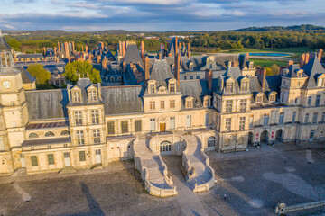 Aerial view of the ChÃ¢teau de Fontainebleau, a royal residence showcasing its ornate architecture and sprawling courtyard, Fontainebleau, ÃŽle-de-France, France.