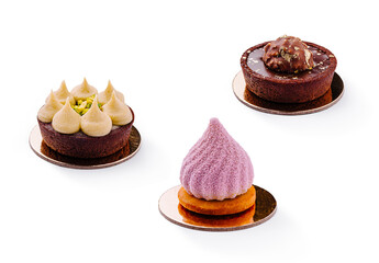 Decadent desserts displayed on circular bases at a pastry shop