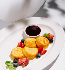 Delightful breakfast platter featuring sweet pancakes with fresh berries