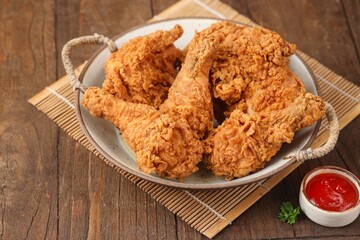 Crispy fried chicken is a dish made from pieces of chicken that have been coated with flour or a thin batter that is seasoned and fried, deep-fried, fried in a pressure fryer, or air-fried.
