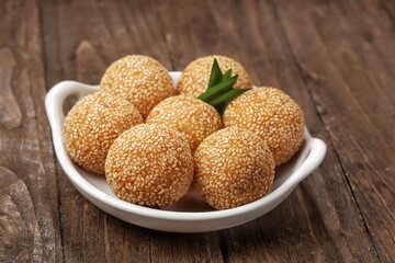 Onde-onde or Kuih Bom or Banh Cam or Jian Dui is a traditional snack made from sticky rice flour with a skin coated with sesame seeds and filled with mungbean