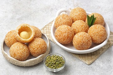 Onde-onde or Kuih Bom or Banh Cam or Jian Dui is a traditional snack made from sticky rice flour with a skin coated with sesame seeds and filled with mungbean