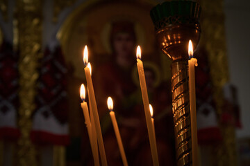 Candlestick with many burning candles in a church