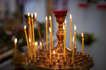 Candlestick with many burning candles in a church