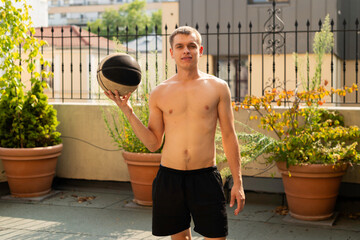 Athletic man with a basketball on a hot day