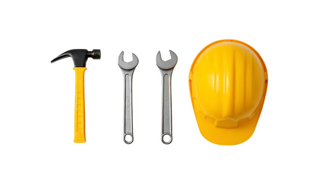 Construction tools including yellow hard hat, hammer, and two wrenches are arranged neatly. This conveys sense of readiness and safety in construction environment