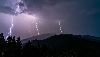 Dramatic nighttime thunderstorm over silhouetted mountains