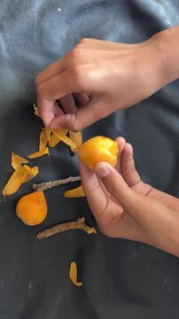 peeling ripe fruit with hands