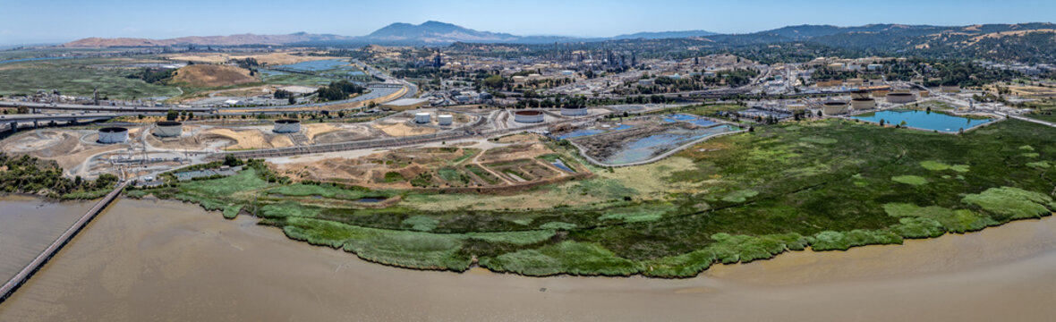 panoramic aerial view of shoreline at Carquinez Strait, from Benicia&ndash;Martinez Bridge (Interstate 680) across industrial area of Martinez, located  in Contra Costa County, California