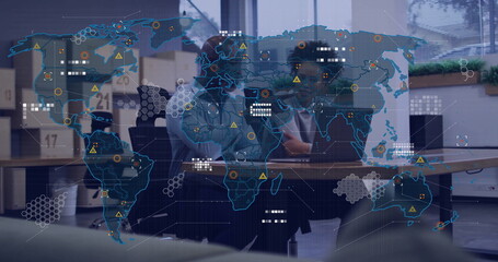 Office colleagues analyzing data points on digital world map overlay in office, with laptops