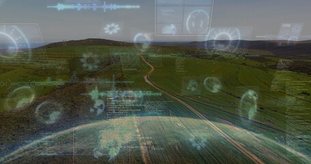 Displaying aerial rural farmland intersecting dirt track beneath pale sky, with digital HUD panels