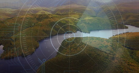 Revealing reservoir cutting through grassy hills in mountain valley, with grid and reticle overlay