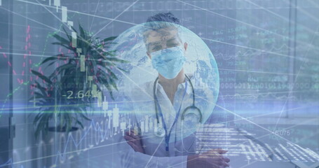Analyzing financial data overlays, senior doctor standing in exam room, with stethoscope and mask