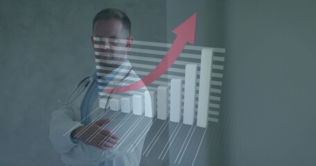 Standing physician wearing coat and stethoscope against grey wall, showing 3D chart with red arrow