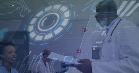 Reviewing charts, male doctor working at desk in clinic with holographic panels, copy space