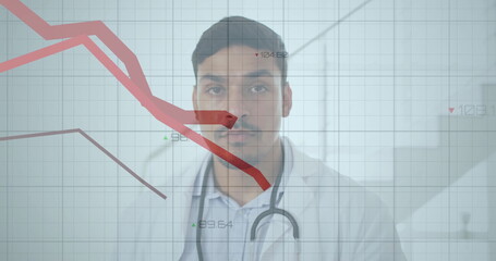 Analyzing mid-adult doctor wearing coat and stethoscope in clinic, with grid chart and red lines