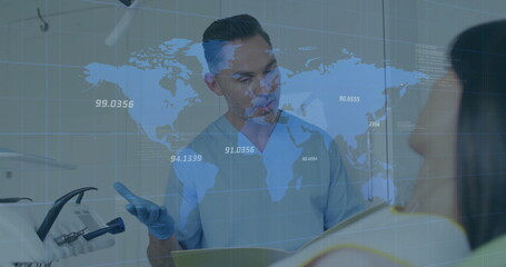 Dentist in scrubs and gloves consulting patient at dental chair, with clipboard, world map overlay