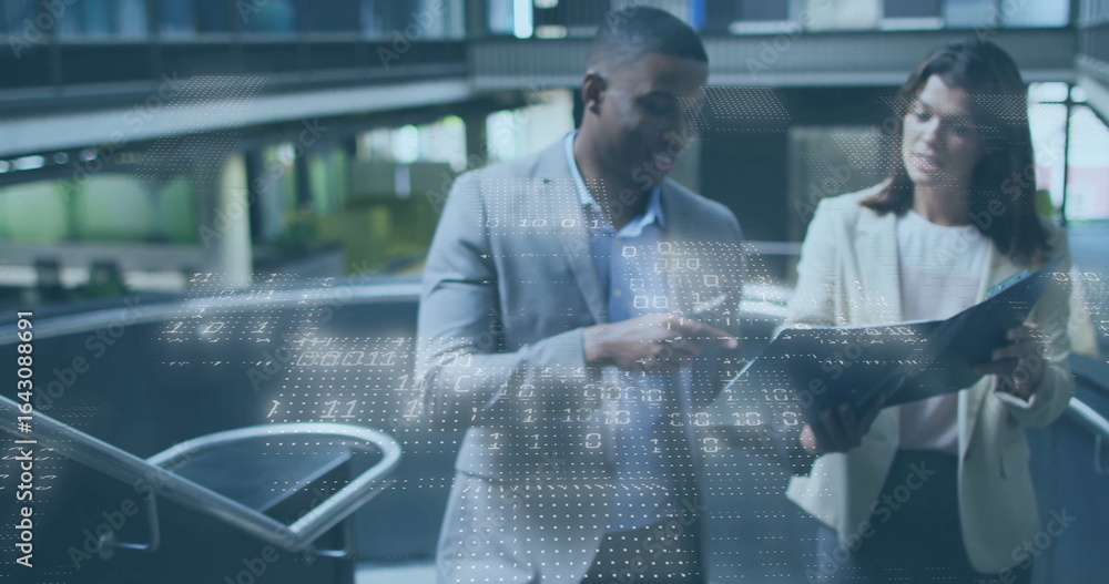 Poster studying colleagues in suits pointing and scanning files in office atrium, with black binder folder
