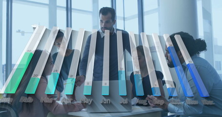 Team in suits reviewing data on laptop at conference table with coffee mug, bar chart overlay