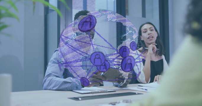 Discussing team in suits typing on keyboard, reviewing papers in boardroom, with network globe - Powered by Adobe