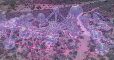 Floating see-through 3D molecular model drifting over desert scrub with pink nodes and rods
