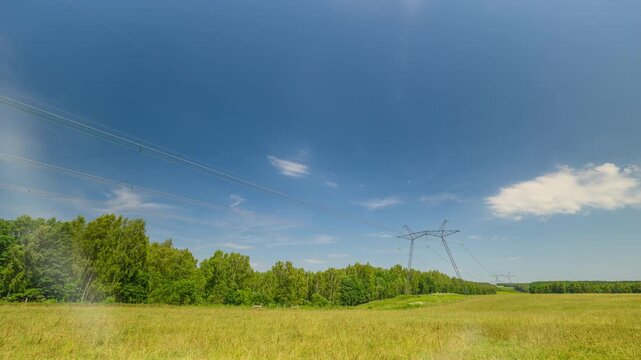 A power transmission line PTL support pointing upward against a blue sky.