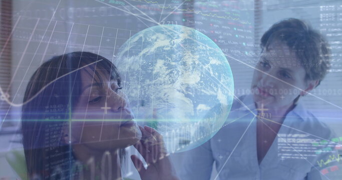 Two business professionals analyzing data in meeting room, with holographic globe and code overlays