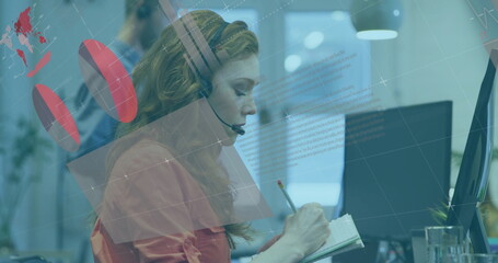 Writing woman wearing orange blouse and headset taking notes in spiral notebook at desk, copy space