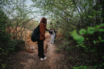 A group of friends enjoying an adventure outdoors, navigating a scenic forest path lined with leafy...