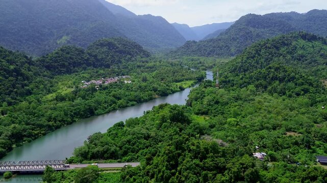 Tropical Mountain Landscape with Long Bridge, River, and Scenic Road Viewed from Above