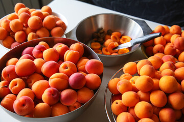 Ripe, juicy apricots in bowls, preparation of apricots for jam
