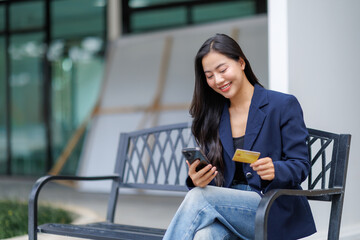 Businesswoman making online payment using credit card and smartphone