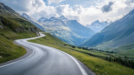 Fototapeta premium Winding mountain road through lush alpine landscape.