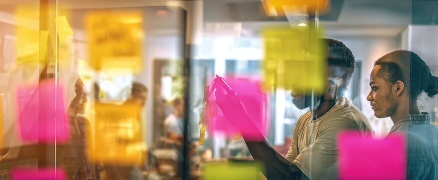 The collaborative brainstorming session with colorful sticky notes in a modern office.