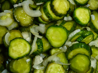 Freshly sliced pickled cucumbers with onions close-up